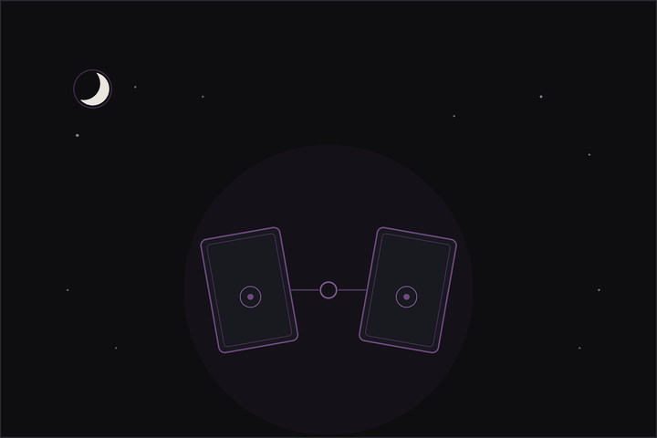 Relationship tarot spread: two tarot cards facing each other, joined at the connection, beneath a crescent moon